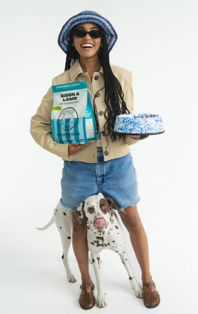 Owner holding a bag of Winnie Lou with her Dalmatian